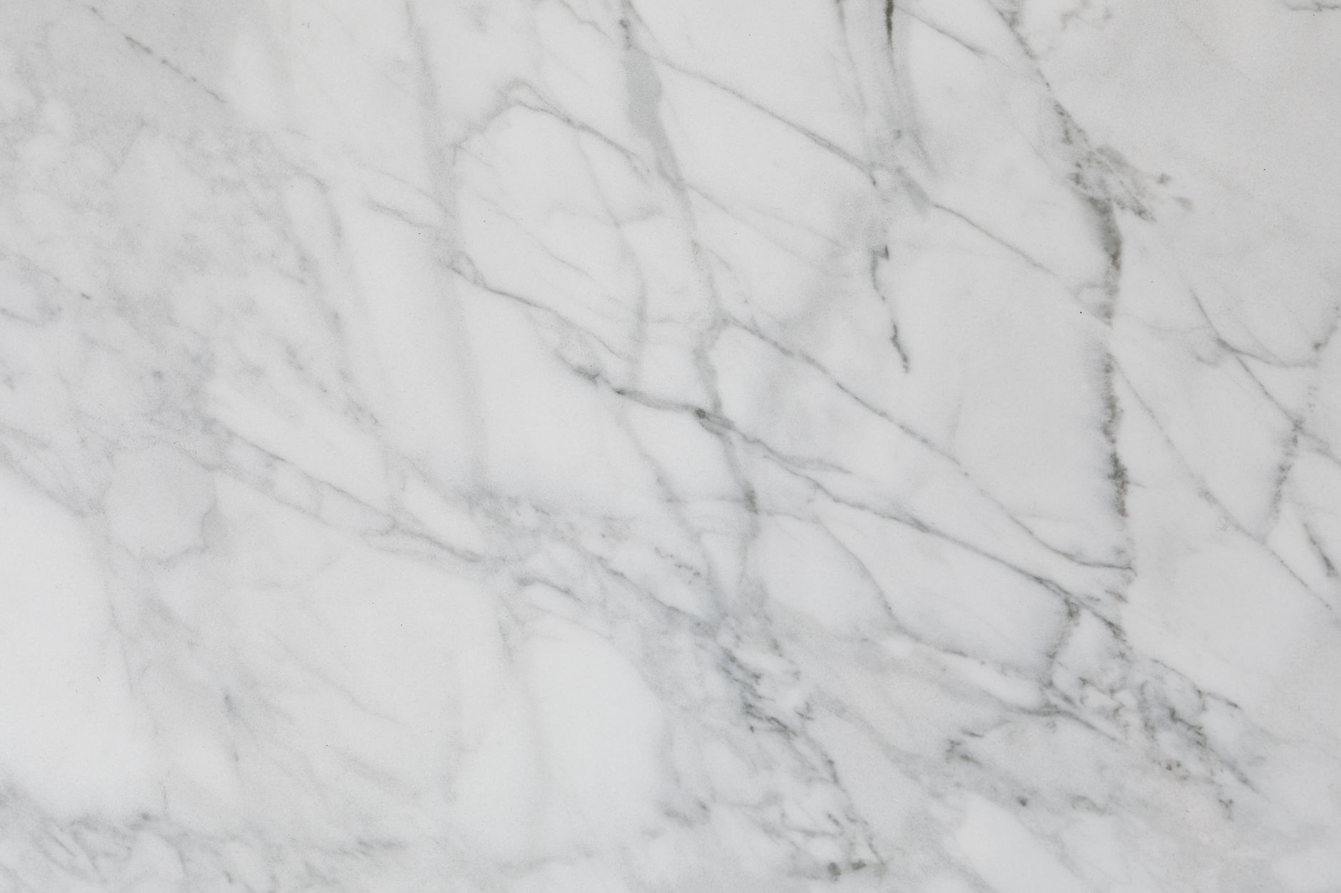 Detailed close-up of white marble texture showcases natural stone patterns with subtle elegance.